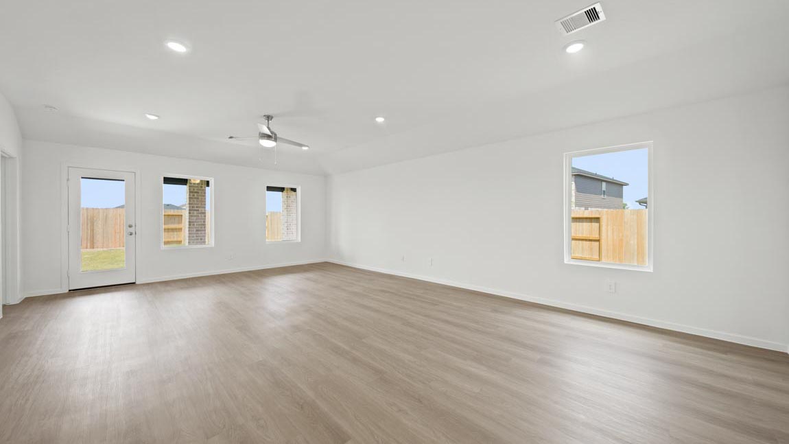 open concept livving and dining area with vinyl flooring and large windows