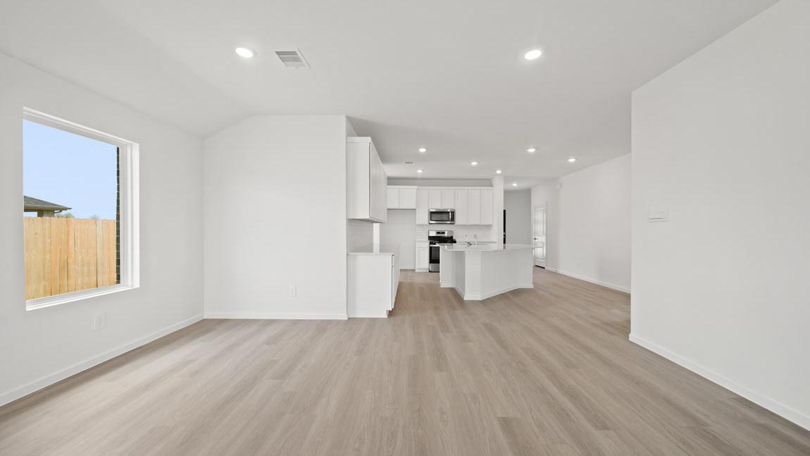 open concept livving and dining area with vinyl flooring and large windows