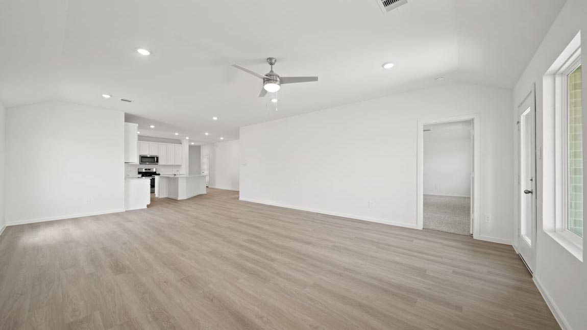 open concept livving and dining area with vinyl flooring and large windows