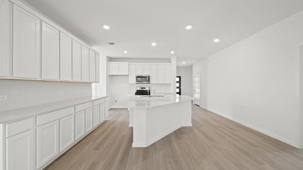 open concept livving and dining area with vinyl flooring and large windows
