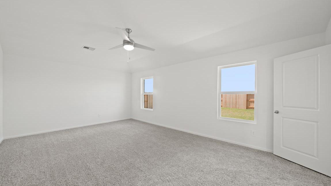 bedroom with carpet flooring and large windows