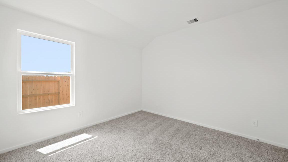 bedroom with carpet flooring and large windows