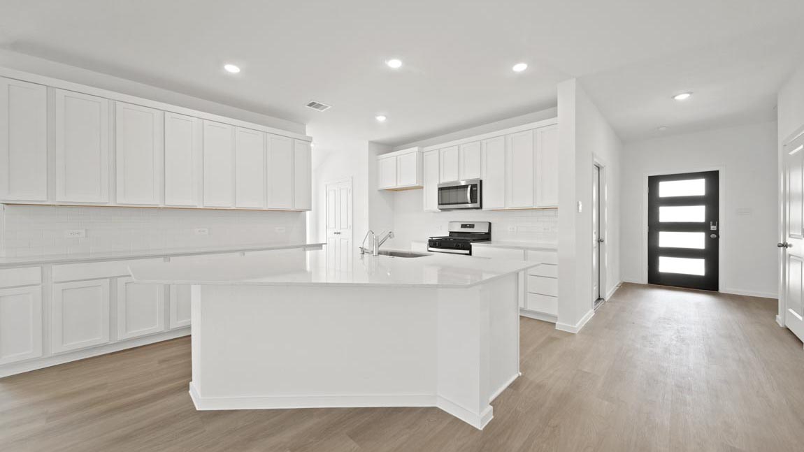 kitchen with quartz countertops, stainless steel appliances, and vinyl flooring