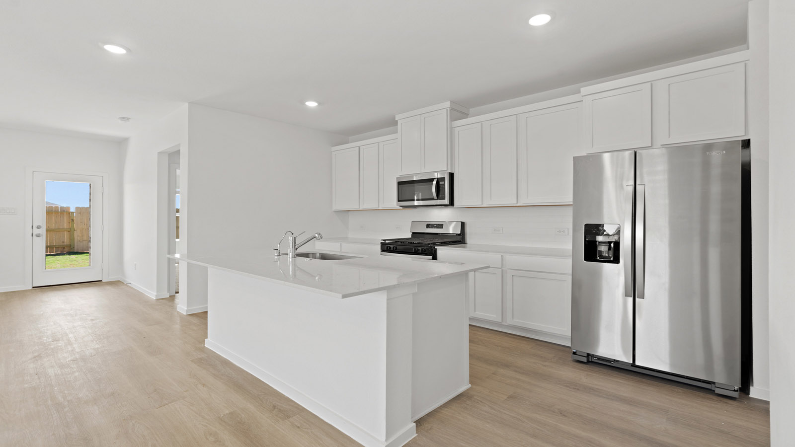 open concept livving and dining area with vinyl flooring, large windows, and quartz countertops
