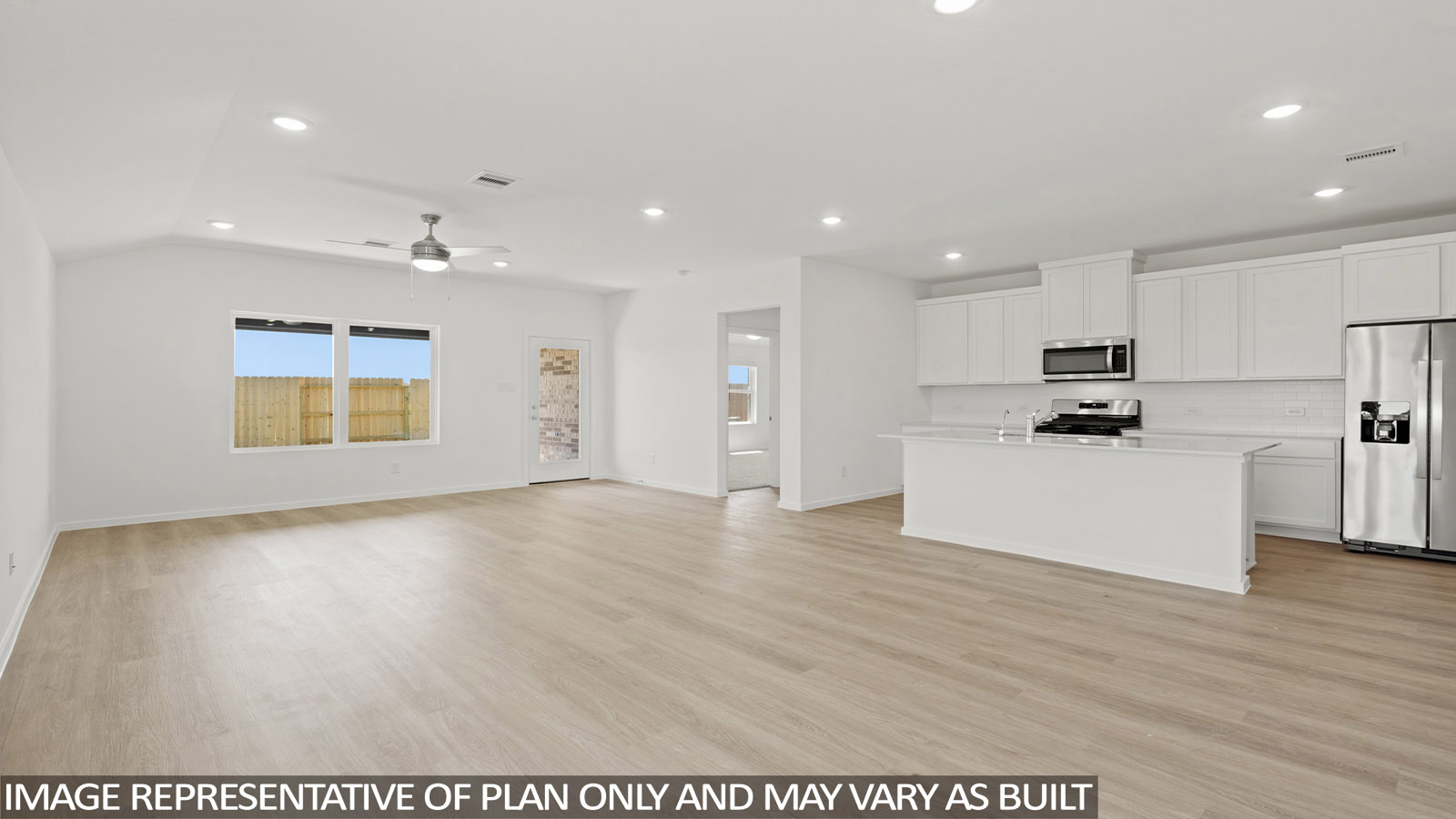 open concept livving and indining area with vinyl flooring, large windows, and quartz countertops