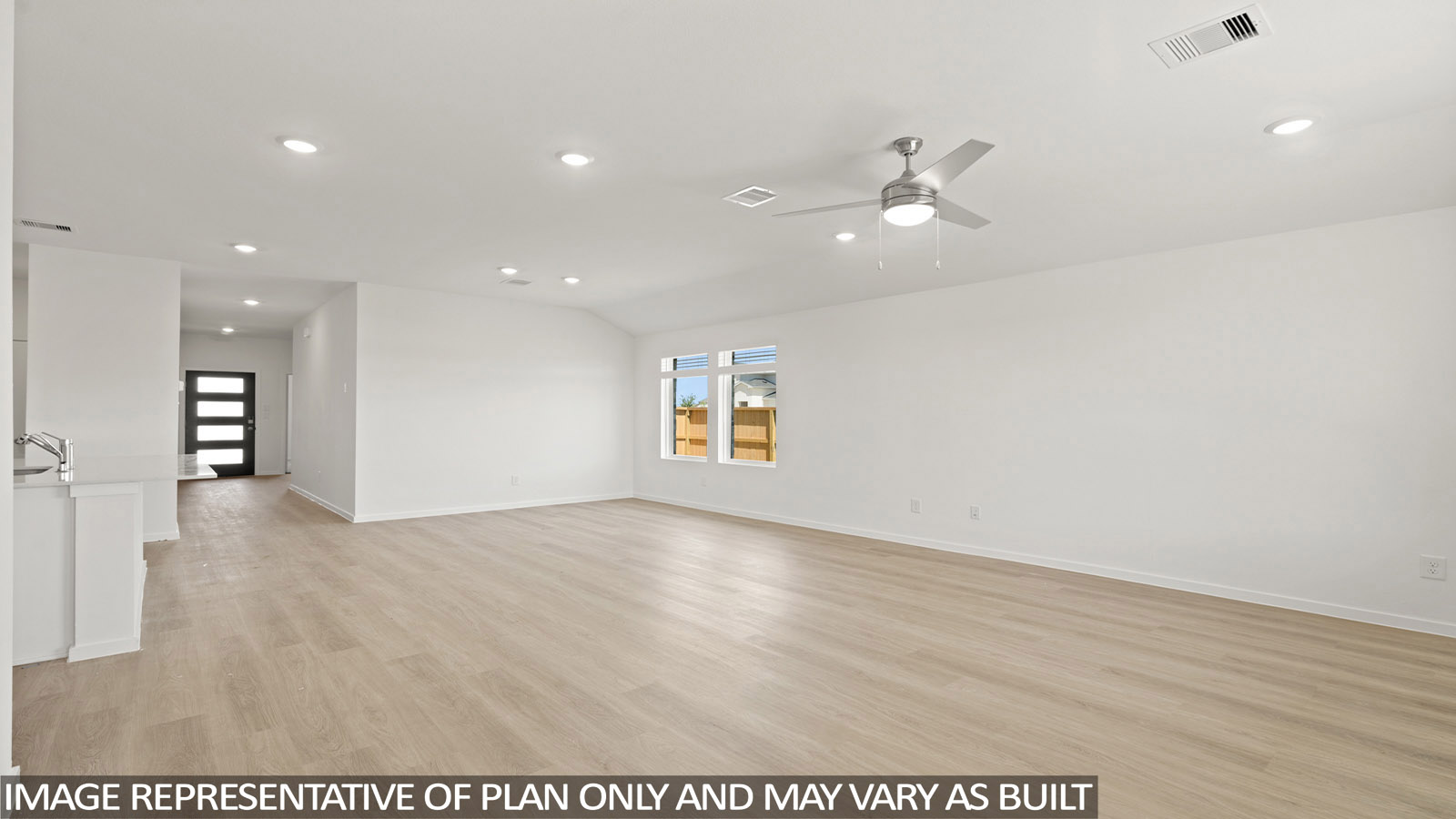 open concept livving and indining area with vinyl flooring, large windows, and quartz countertops