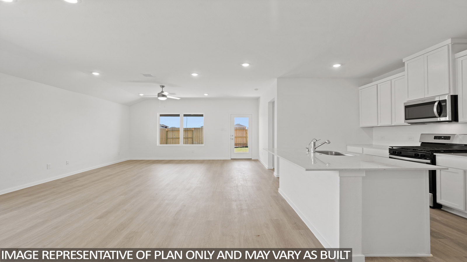 open concept livving and indining area with vinyl flooring, large windows, and quartz countertops