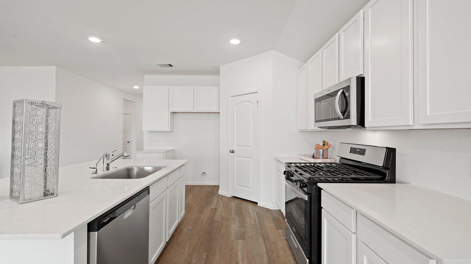 itchen with stainless steel appliances and quartz countertops