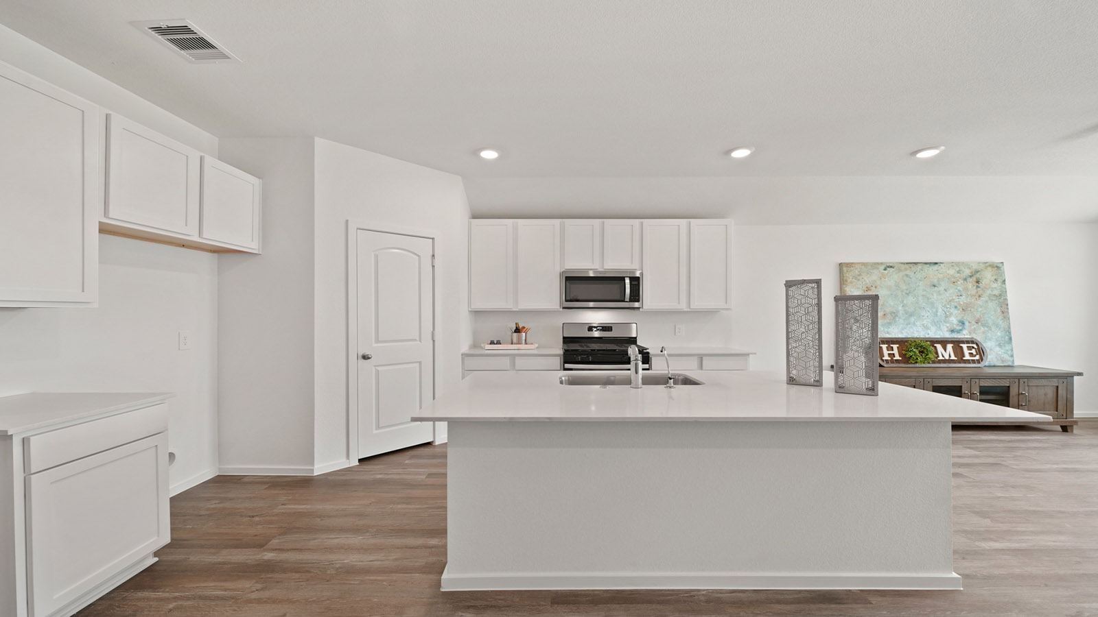 itchen with stainless steel appliances and quartz countertops