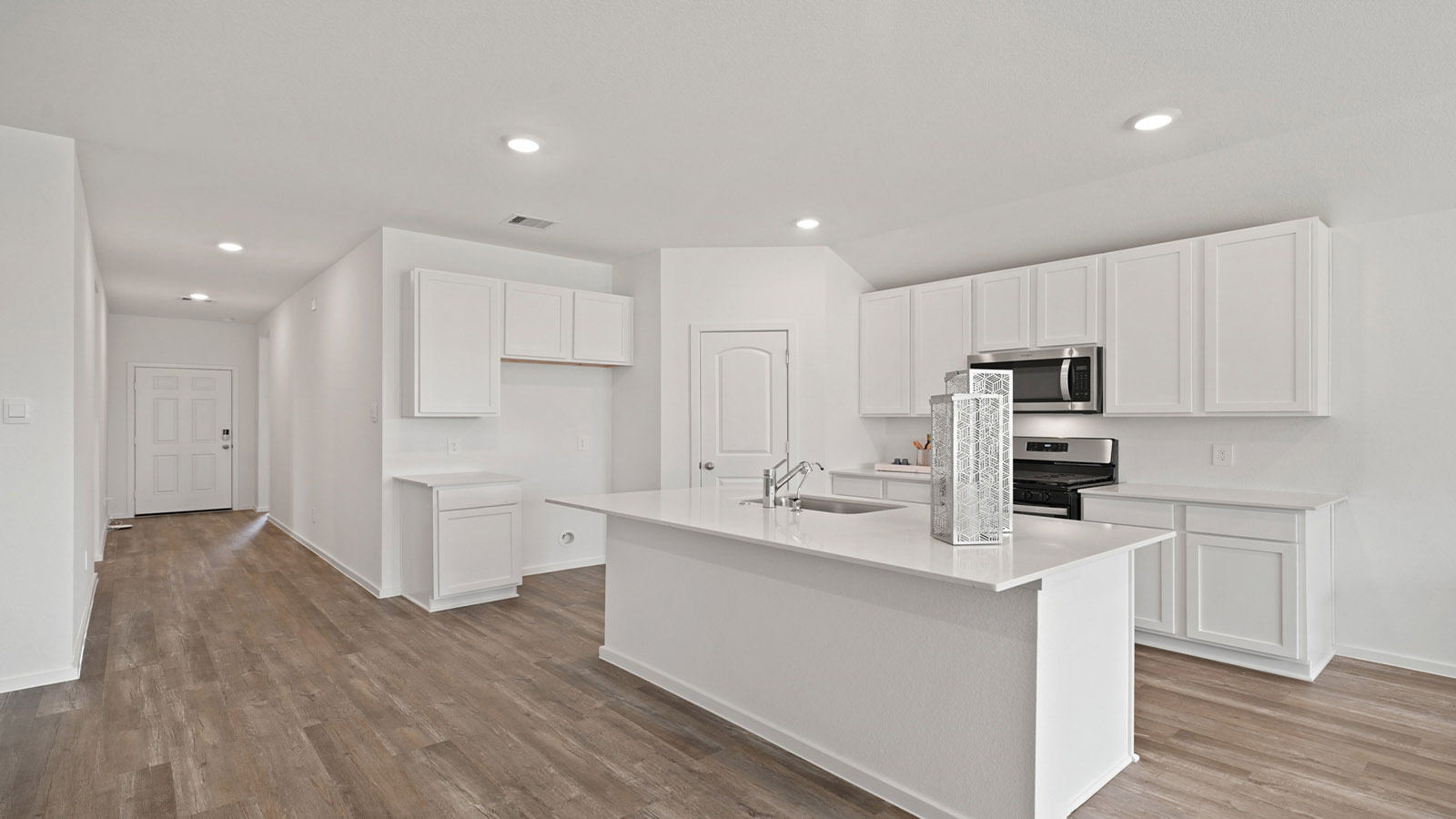 itchen with stainless steel appliances and quartz countertops