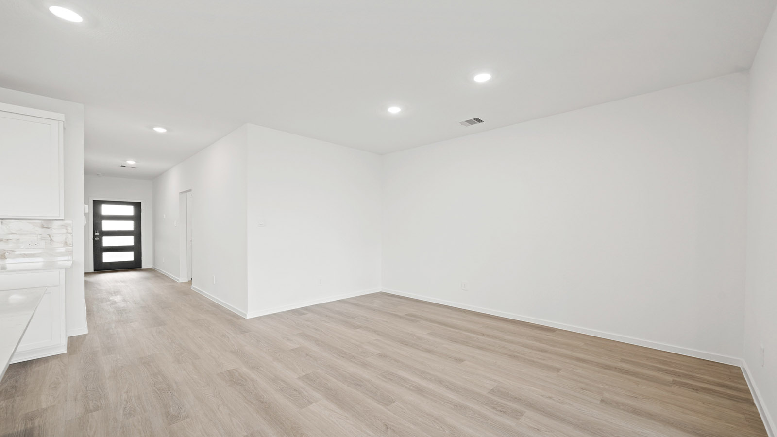 open concept living and dining area with vinyl flooring and large windows