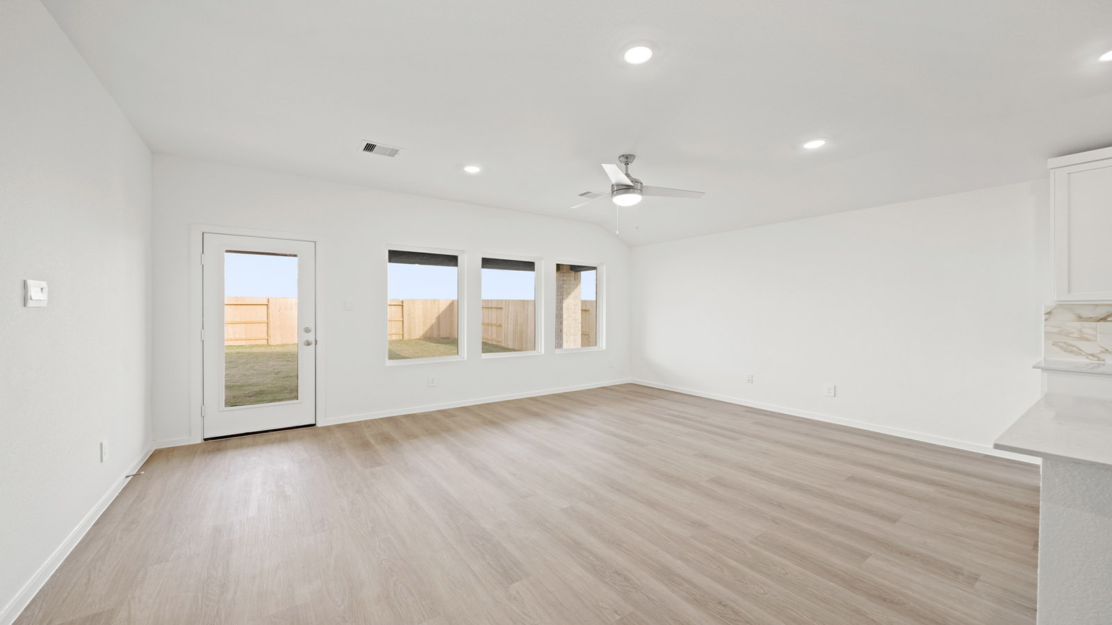 open concept living and dining area with vinyl flooring and large windows