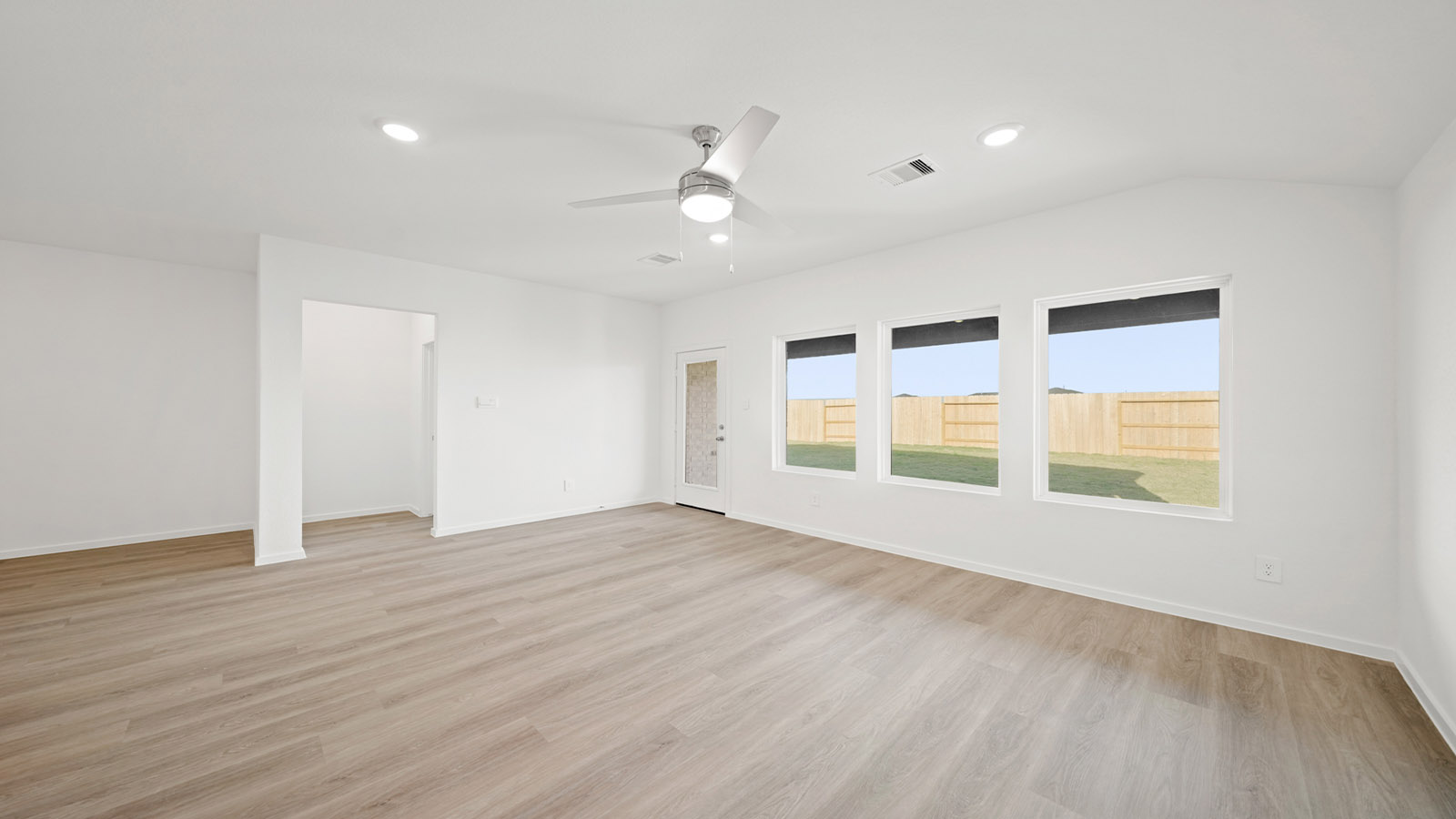 open concept living and dining area with vinyl flooring and large windows