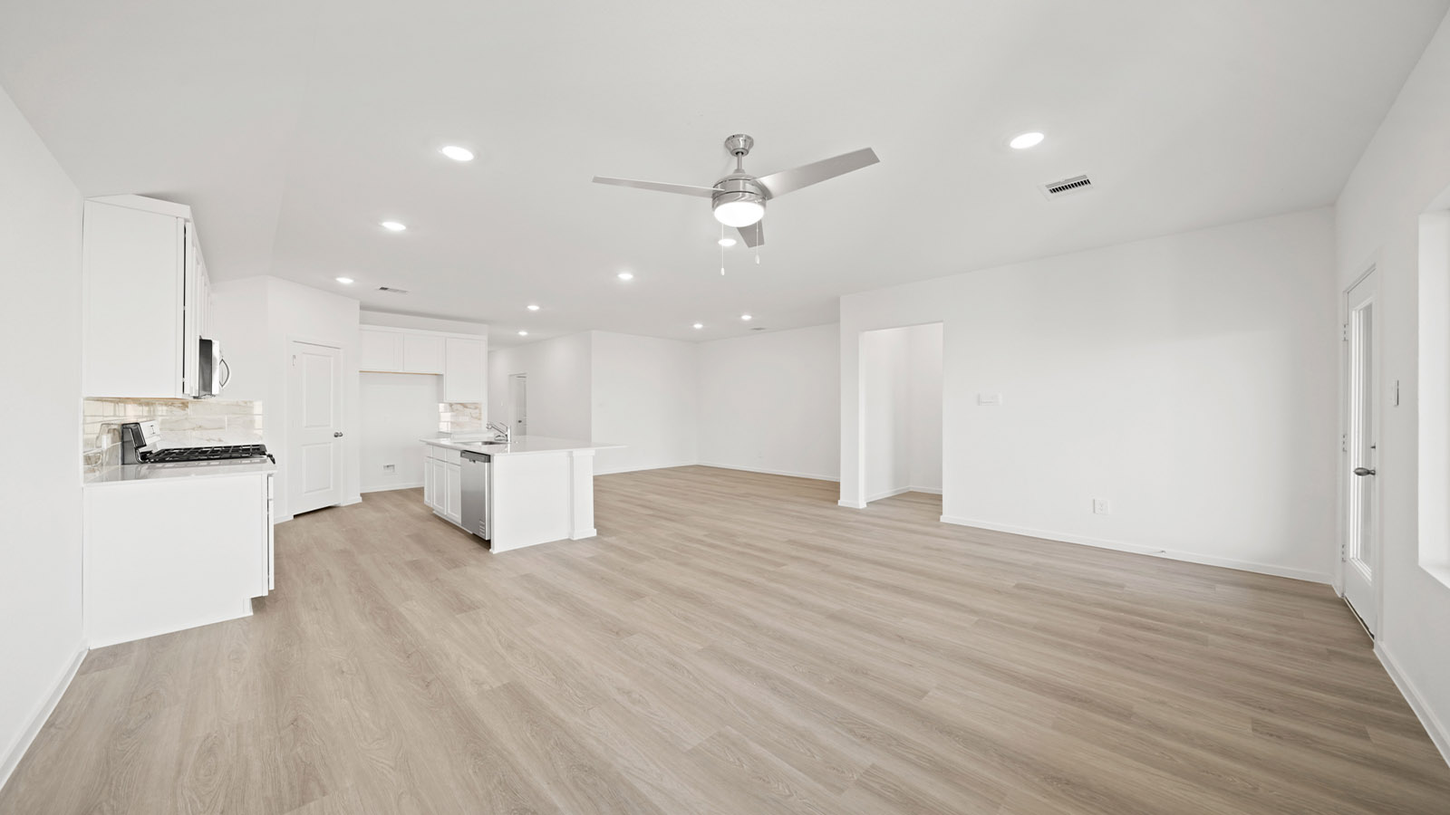 open concept living and dining area with vinyl flooring and large windows