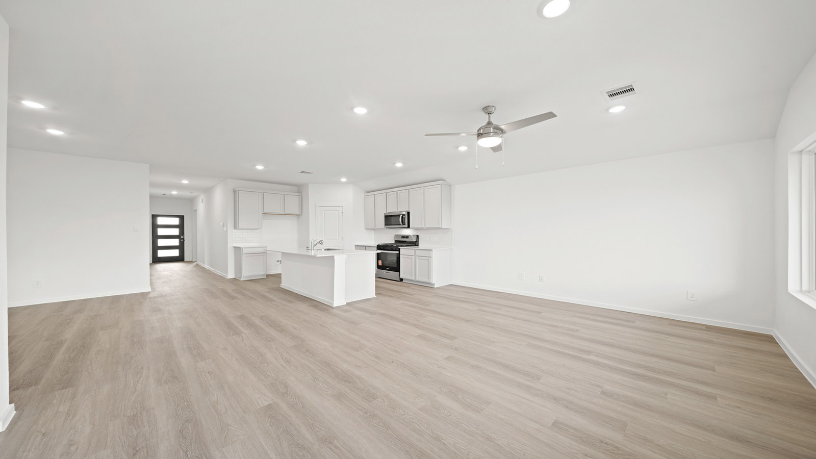 open concept living and dining area with vinyl flooring