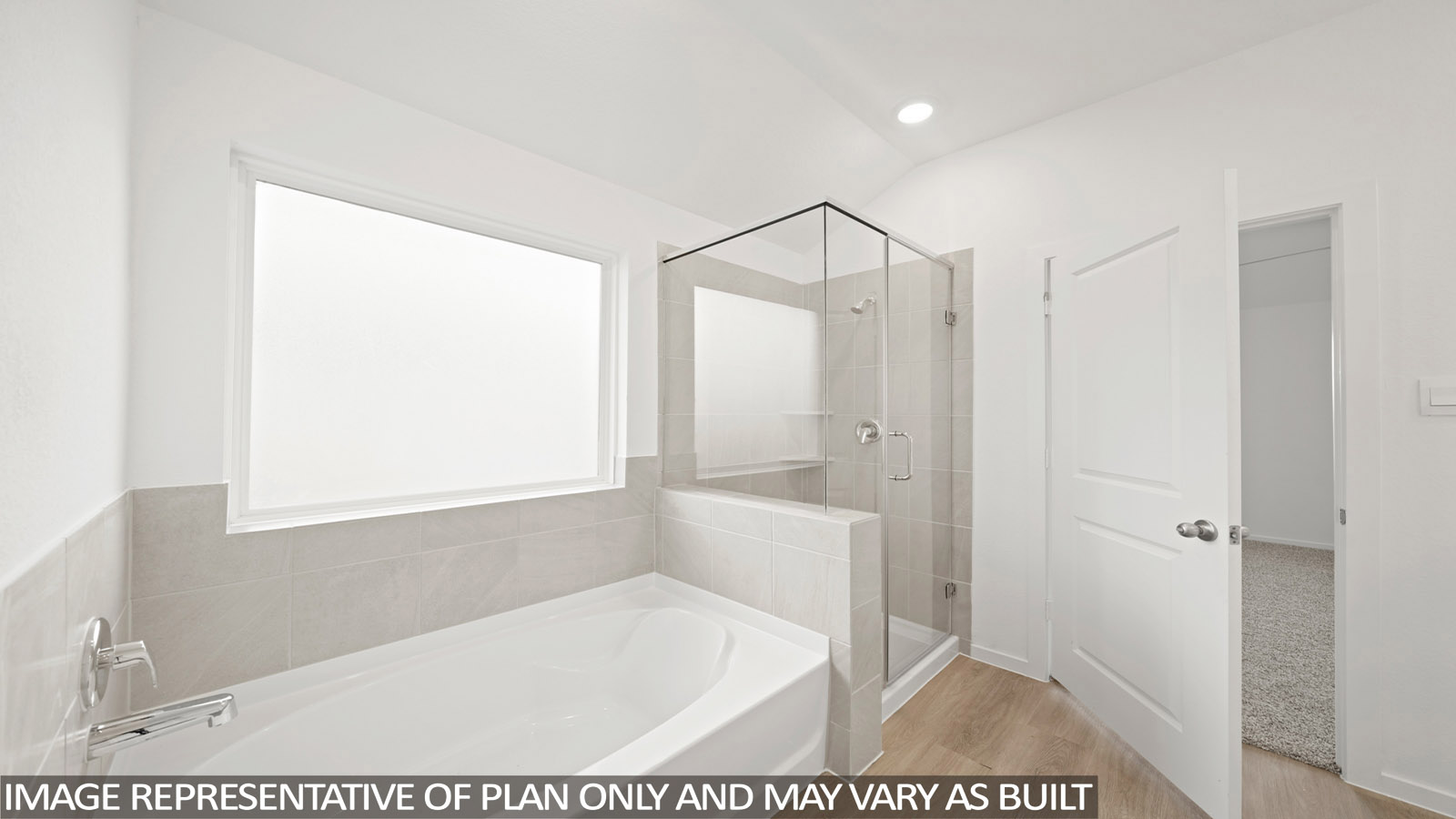 primary bathroom with separate tub and shower