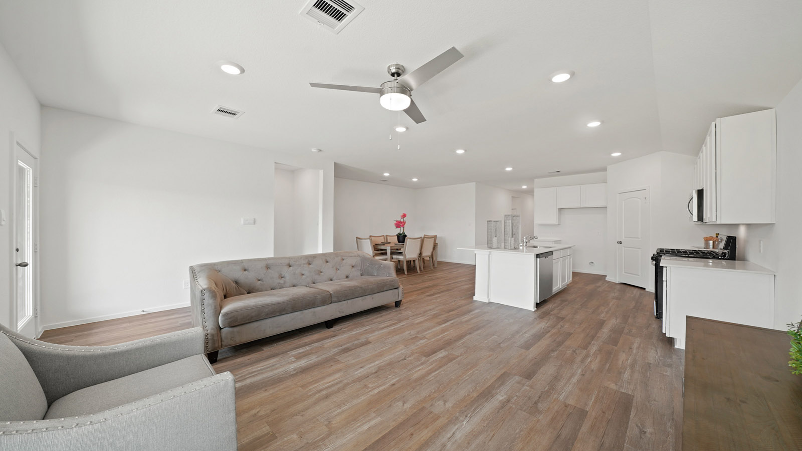 living area with vinyl flooring and large windows