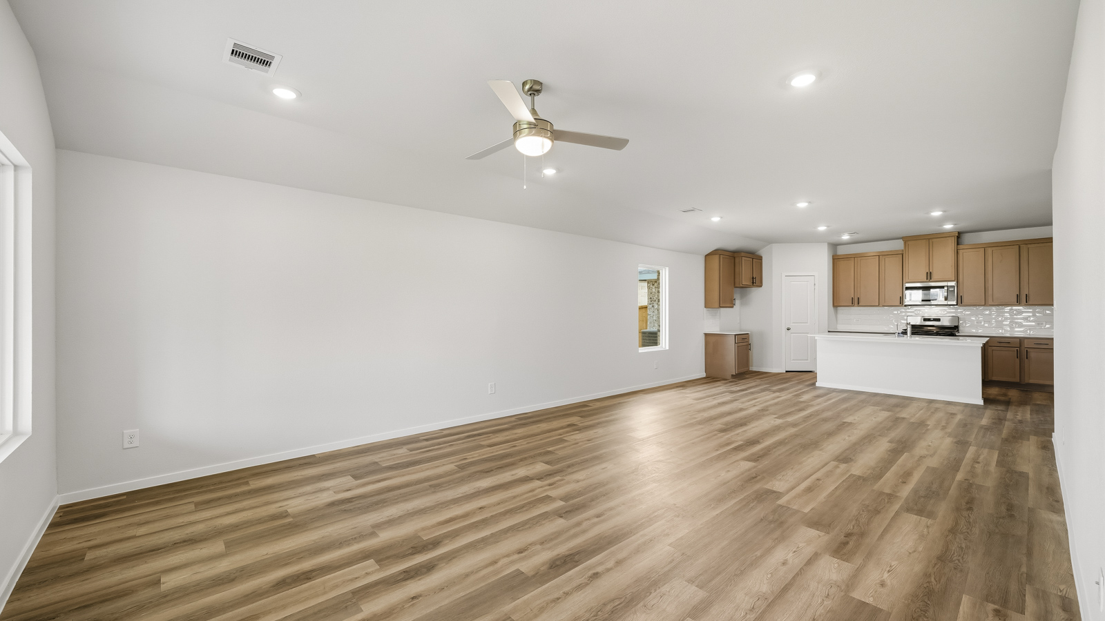 Spacious living area with vinyl flooring and bright windows in Katy TX