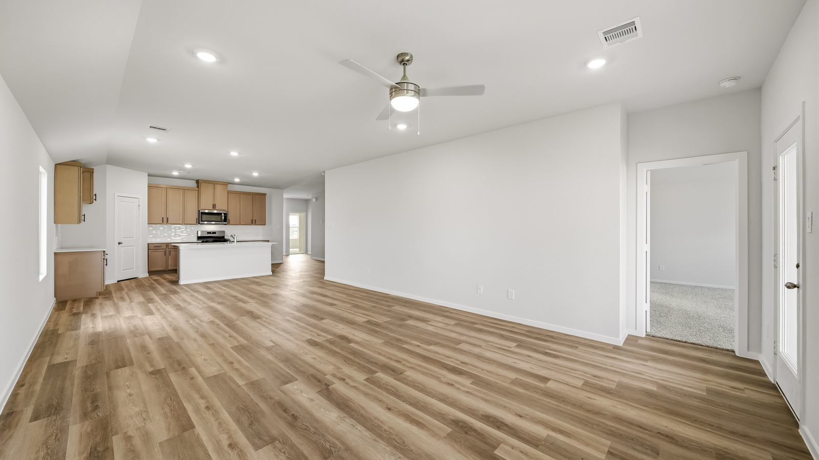 Spacious living area with vinyl flooring and bright windows in Katy TX