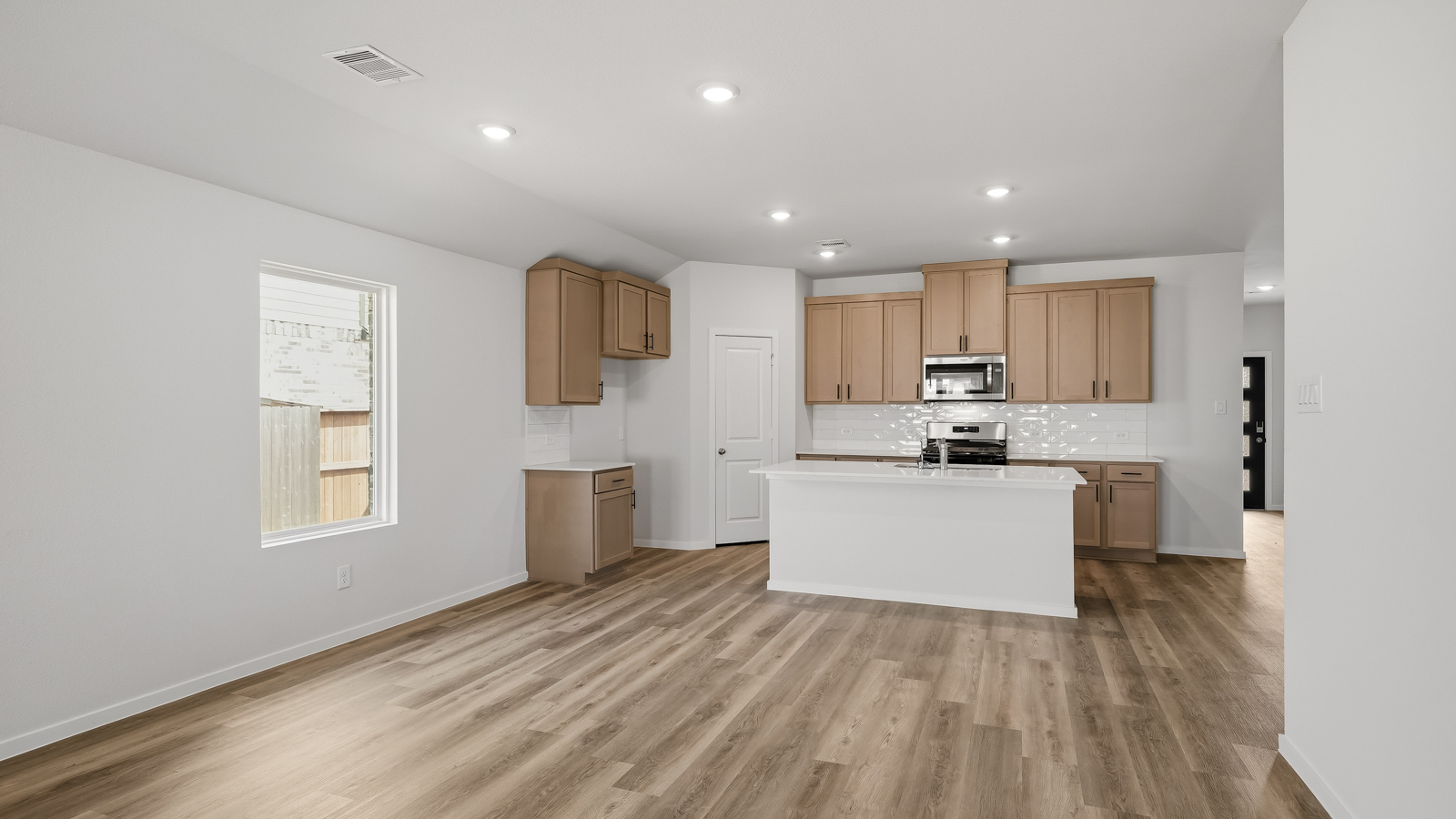Kitchen with quartz countertops and an island and vinyl floor
