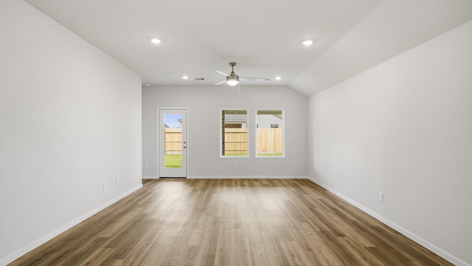 Spacious living area with vinyl flooring and bright windows in Katy TX