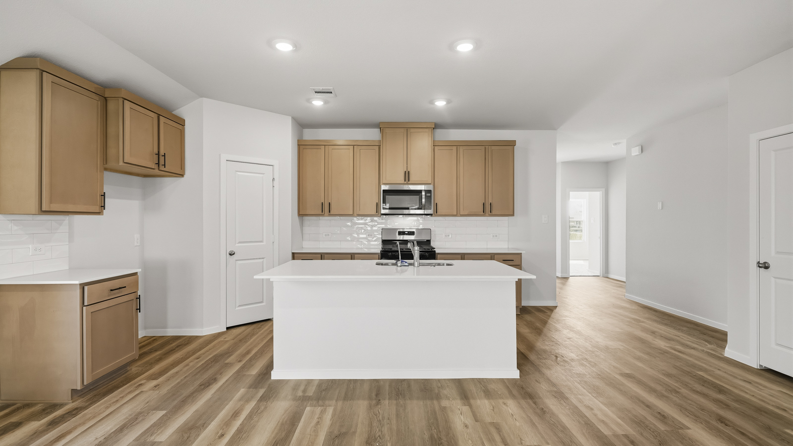 Kitchen with quartz countertops and an island and vinyl floor