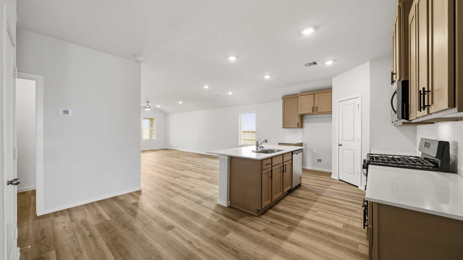 Kitchen with quartz countertops and an island and vinyl floor