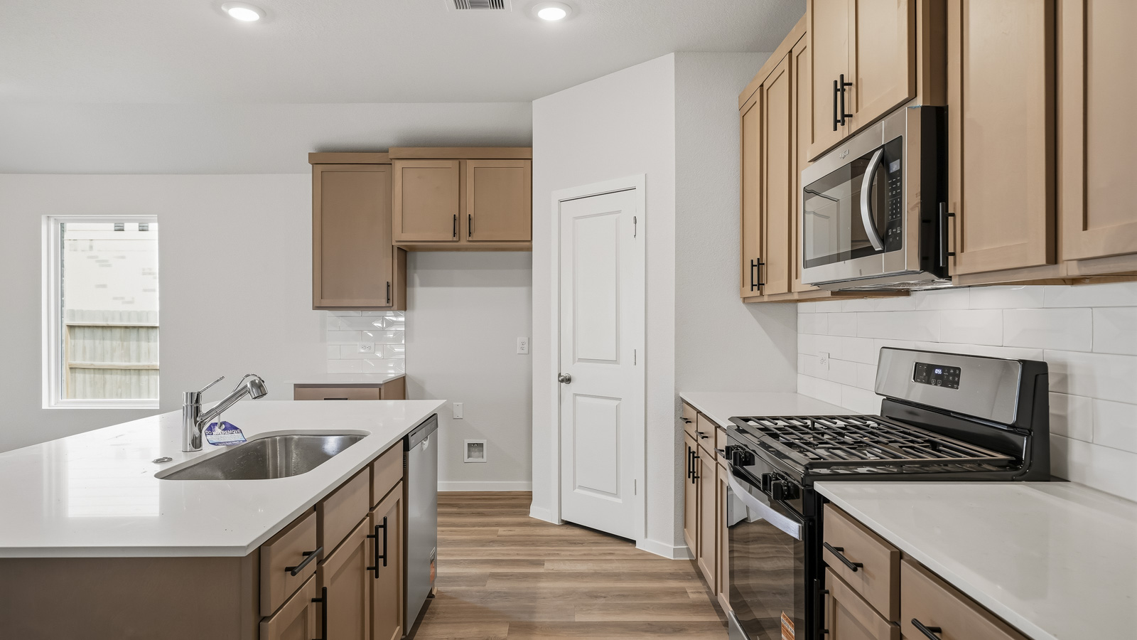 Kitchen with quartz countertops and an island and vinyl floor