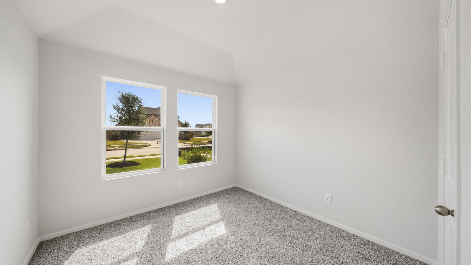 Secondary bedroom with shag carpet flooring and bright window
