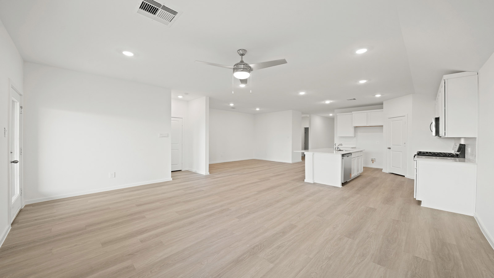 open concept living and dining area with vinyl flooring