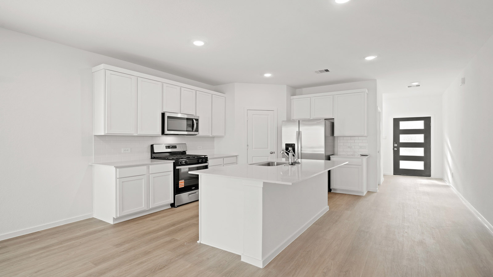 open concept living and dining area with quartz countertops and large windows