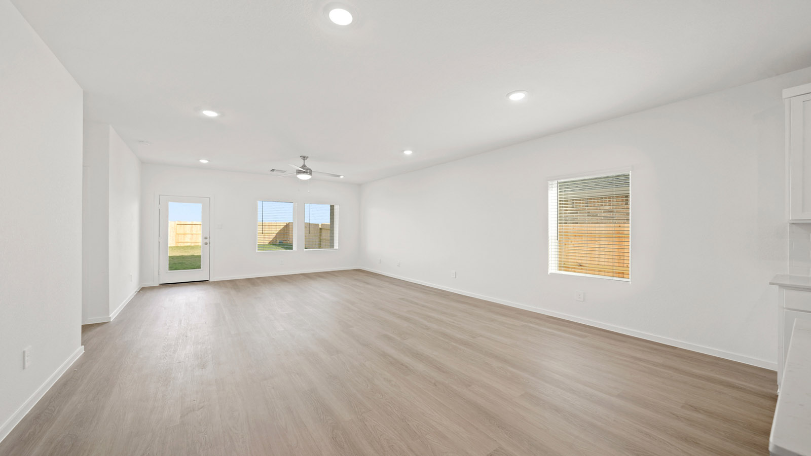 open concept living and dining area with quartz countertops and large windows