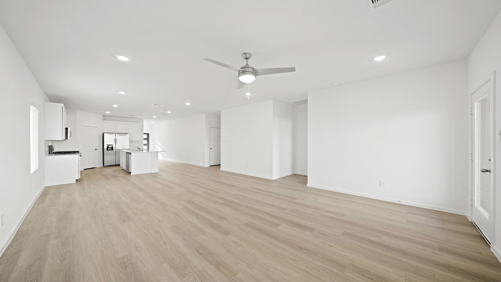 open concept living and dining area with quartz countertops and large windows