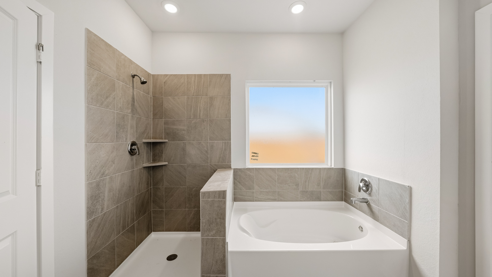 primary bathroom with separate tub and shower