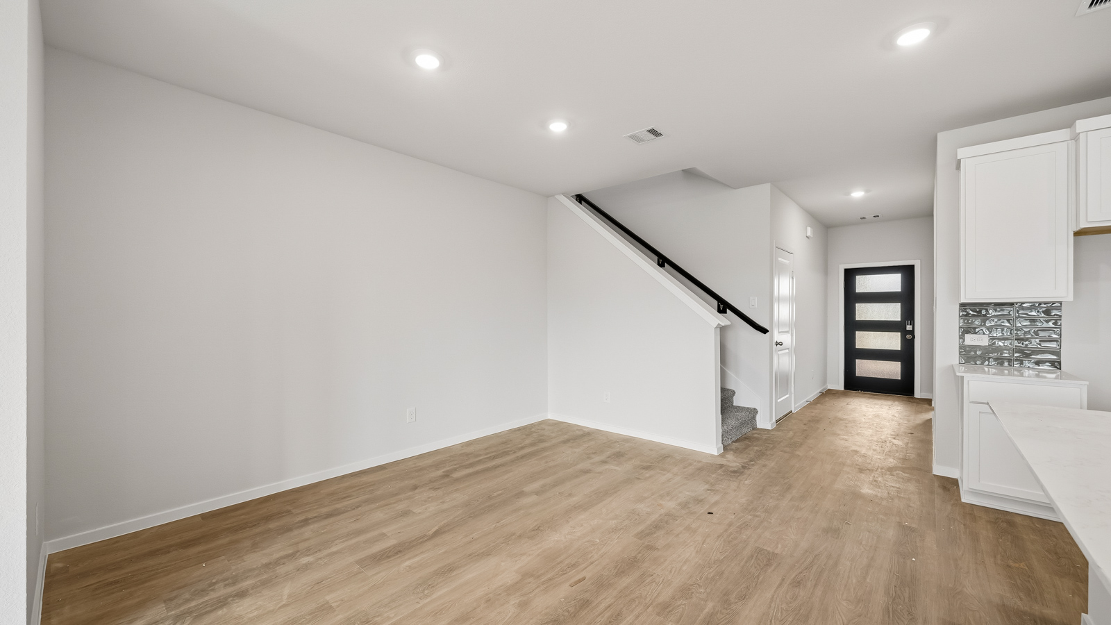open concept living and dining area with vinyl flooring and large windows
