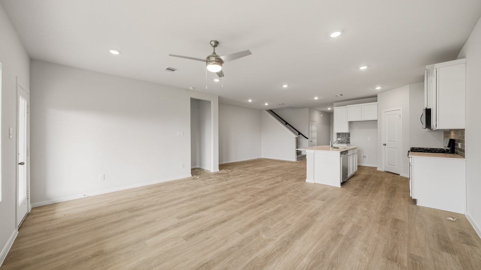 open concept living and dining area with vinyl flooring and large windows