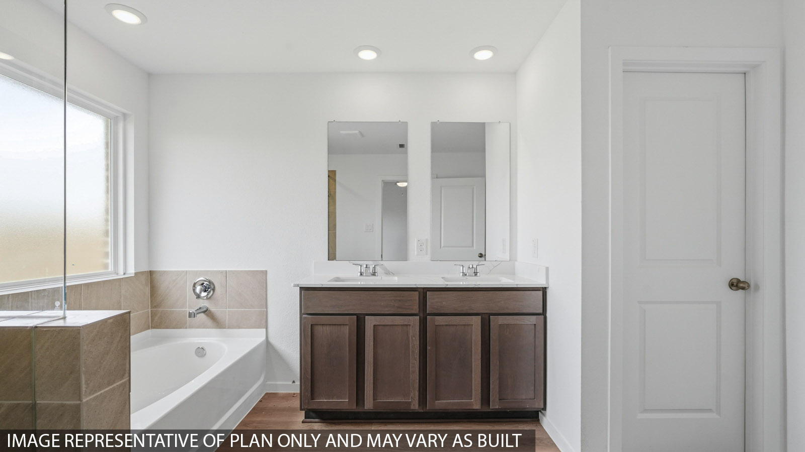 primary bathroom with separate tub and bathroom