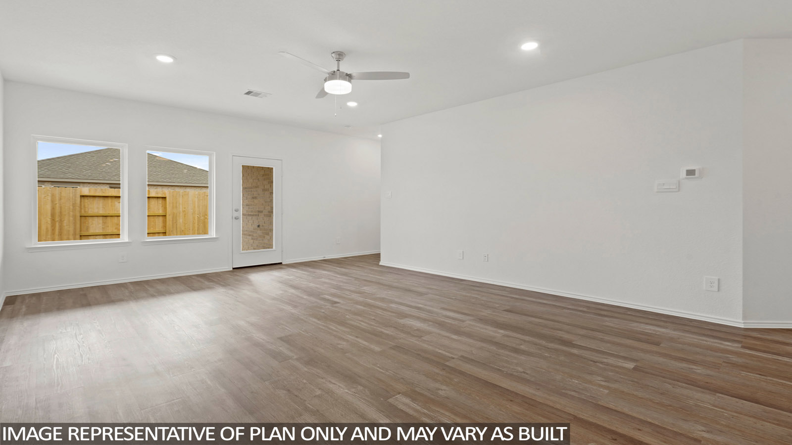 open concept living and dining area with vinyl flooring and large wwdo
