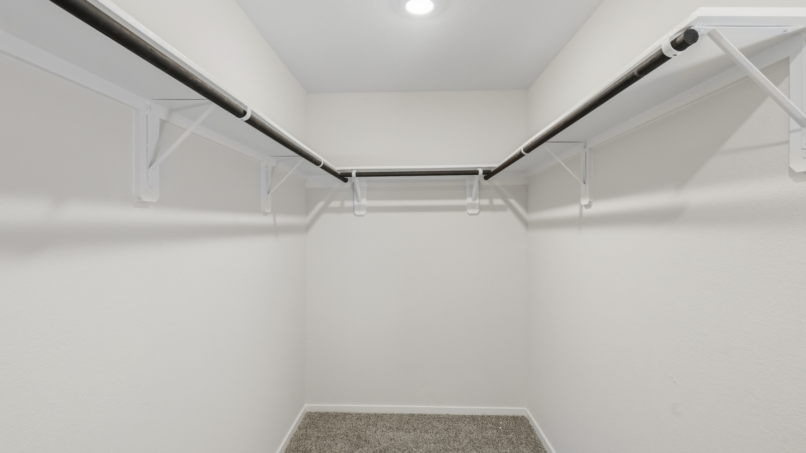 Primary bathroom with stand-alone shower with tiles and semi frameless glass in Katy TX