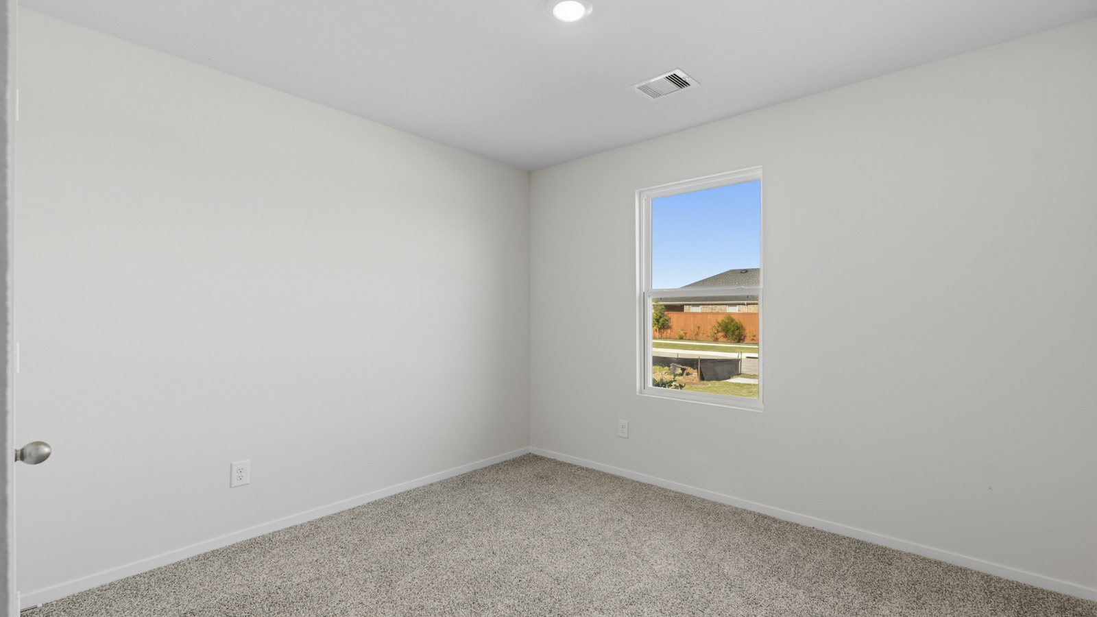 Secondary bedroom with shag carpet flooring and bright window