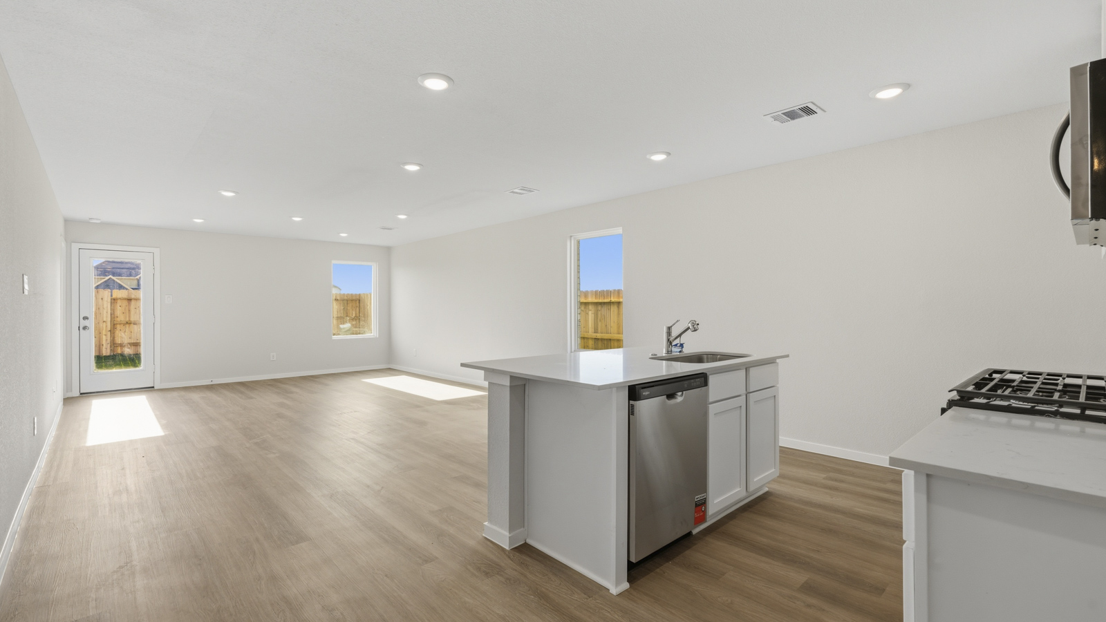Kitchen with quartz countertops and an island and vinyl floor