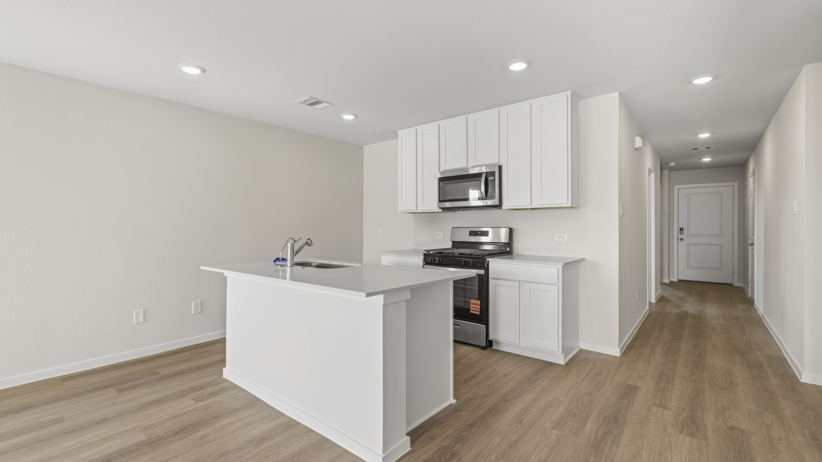Kitchen with quartz countertops and an island and vinyl floor