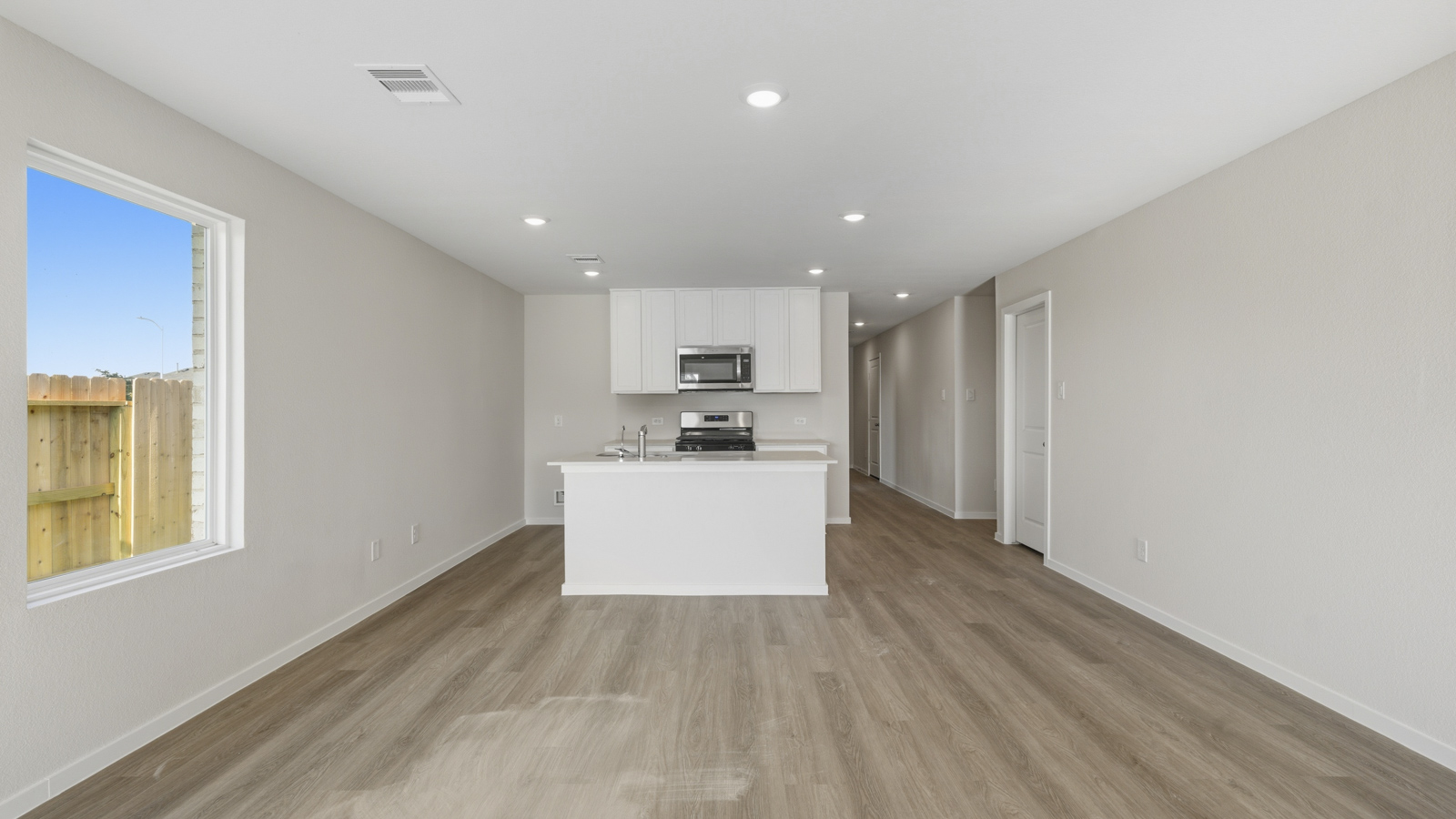 Spacious living area with vinyl flooring and bright windows in Katy TX