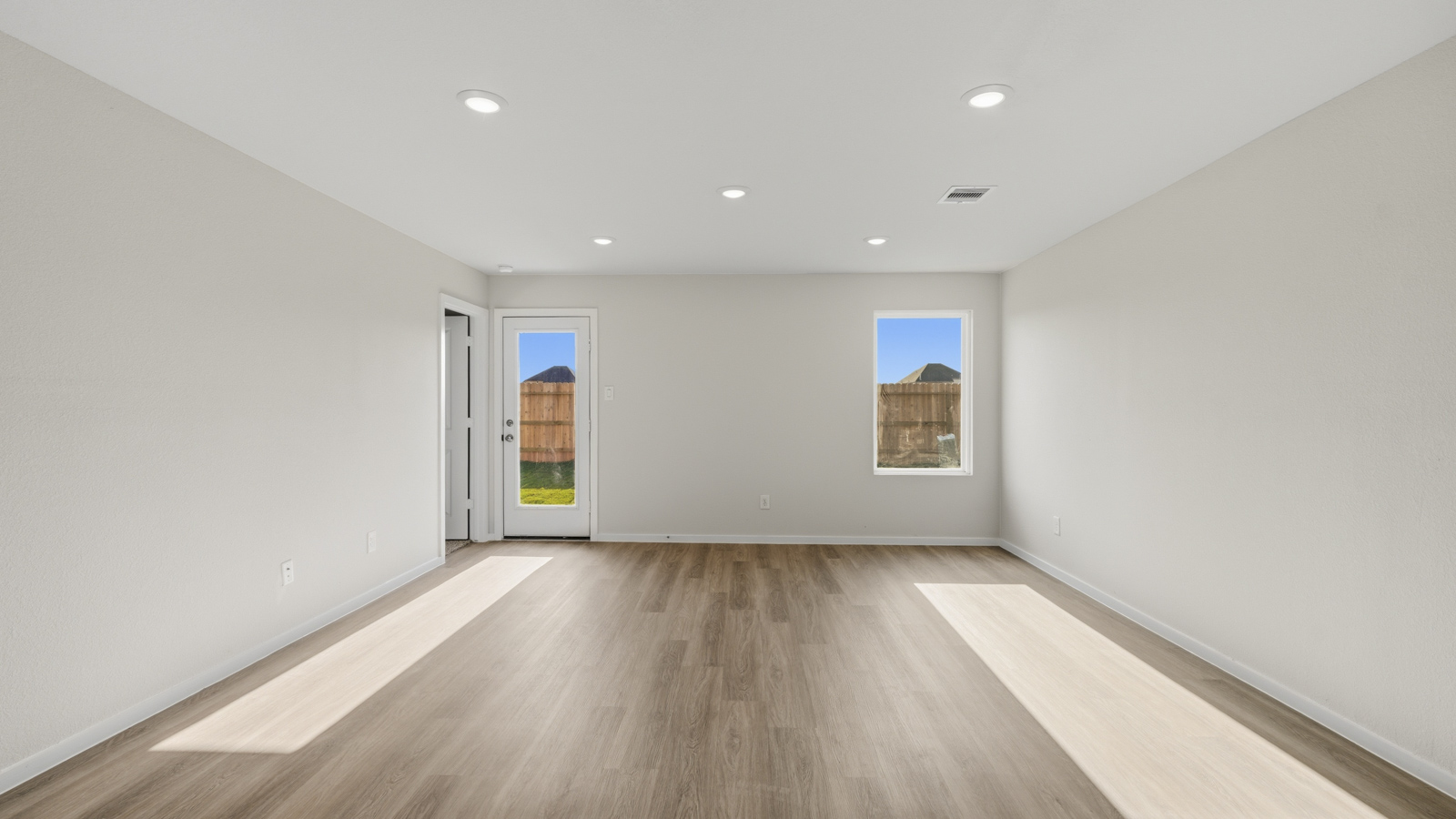 Spacious living area with vinyl flooring and bright windows in Katy TX