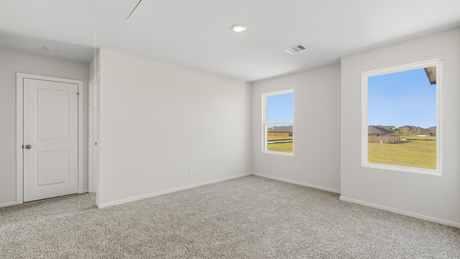 Secondary bedroom with shag carpet flooring and bright window