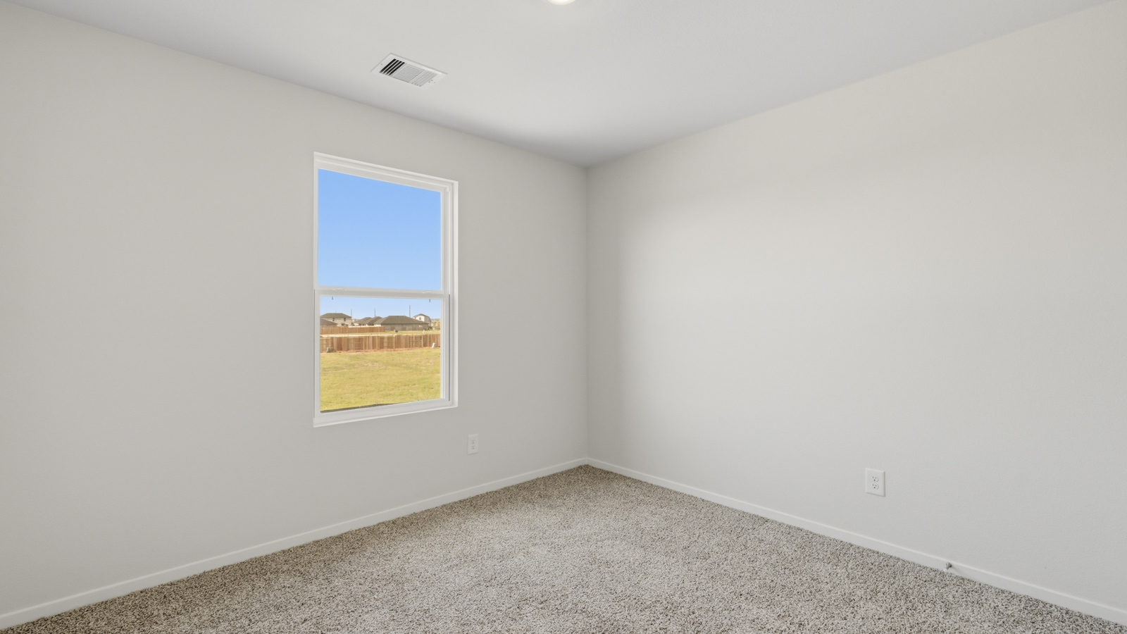 Secondary bedroom with shag carpet flooring and bright window