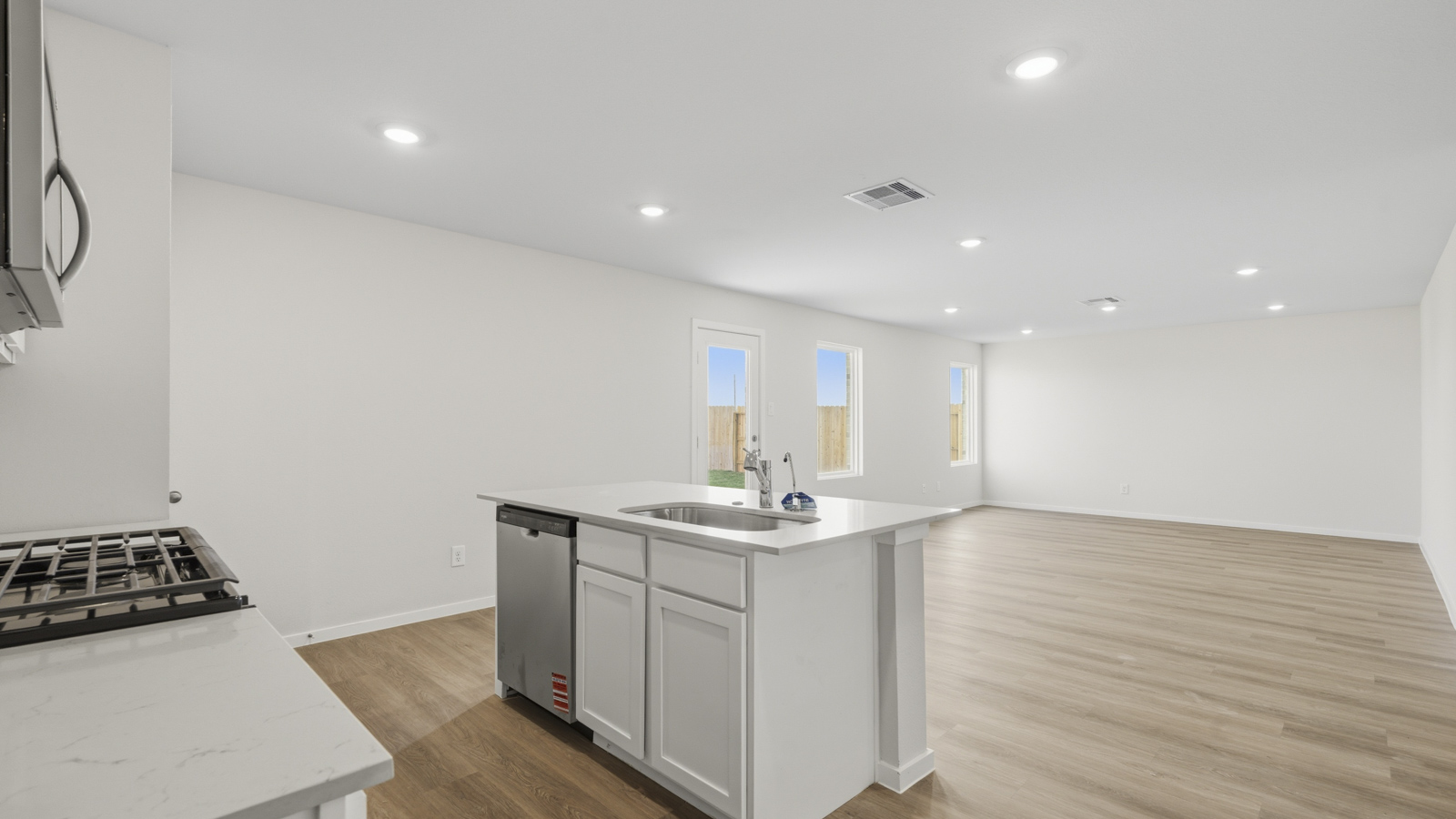 Spacious living area with vinyl flooring and bright windows in Katy TX