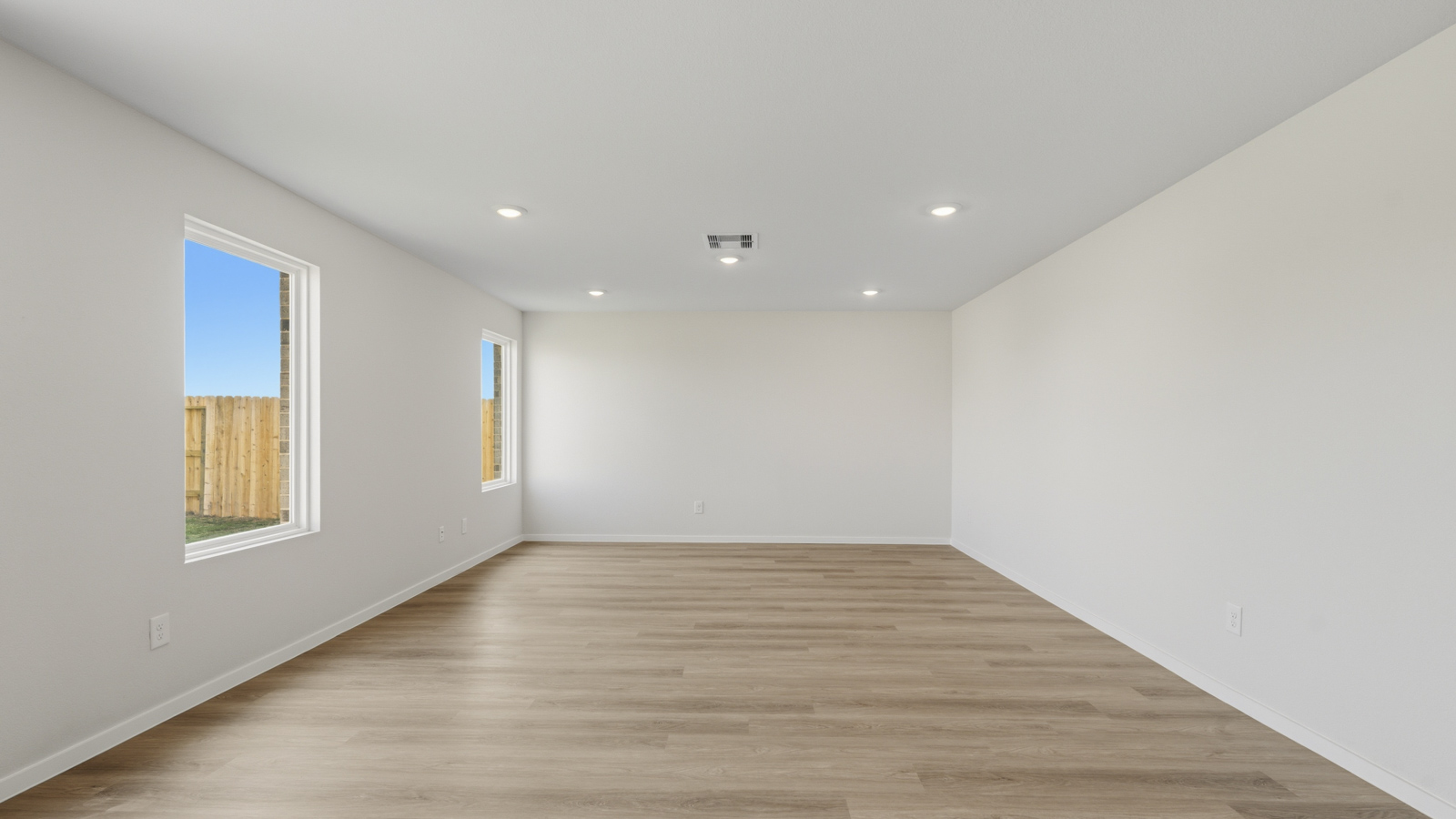 Spacious living area with vinyl flooring and bright windows in Katy TX