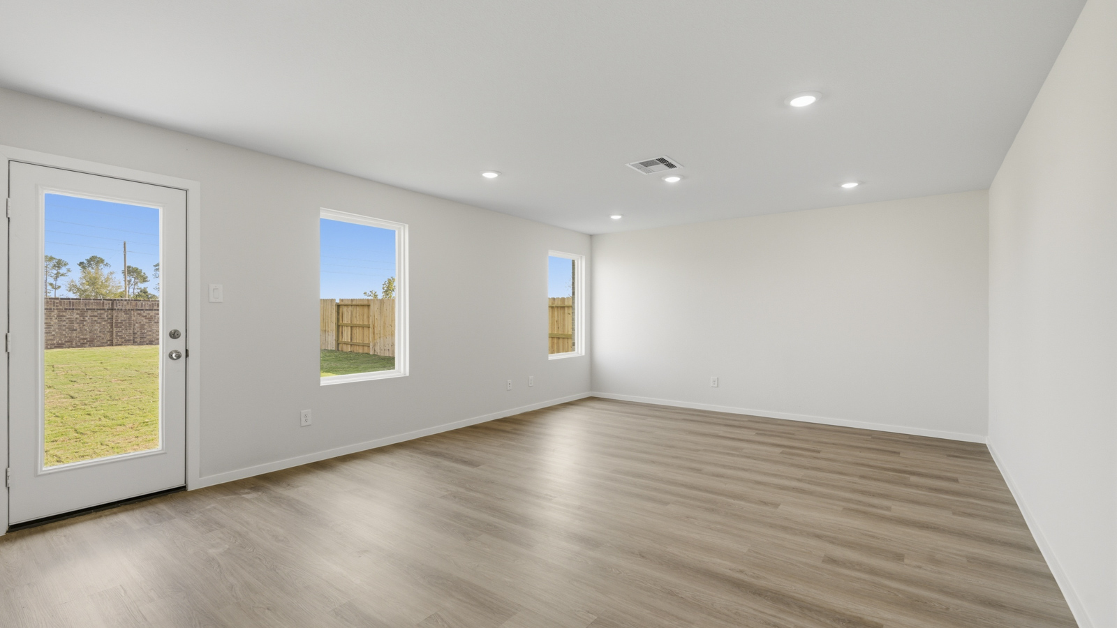 Spacious living area with vinyl flooring and bright windows in Katy TX