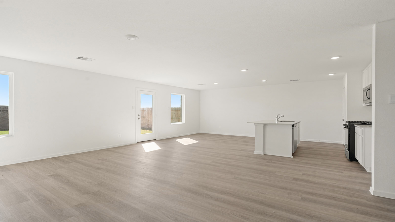 open concept living and dining area with vinyl flooring